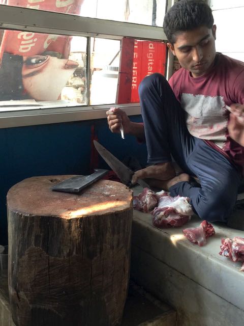 butcher cutting goat